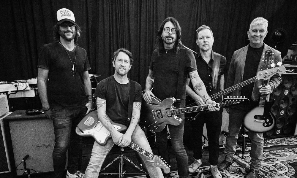 A black and white image of the Foo Fighters with their instruments.